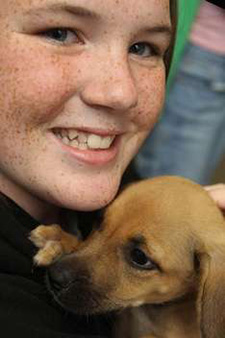 Young girl smiling with a dog